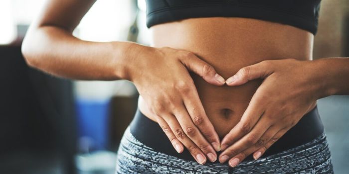 woman holding her hand over her belly