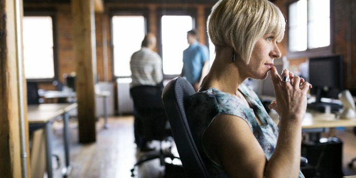 person in thought at the desk