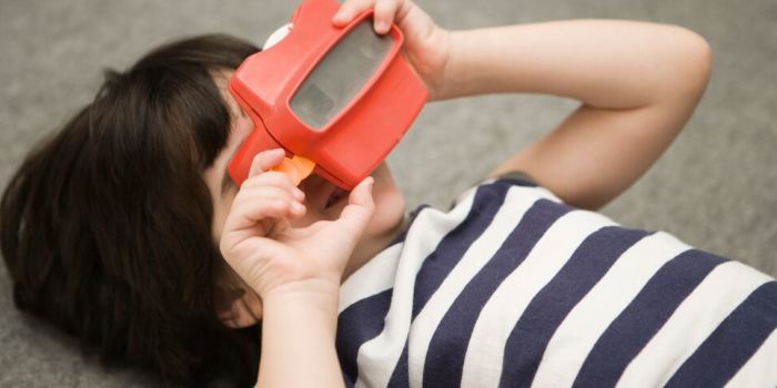 child playing with a slide viewer