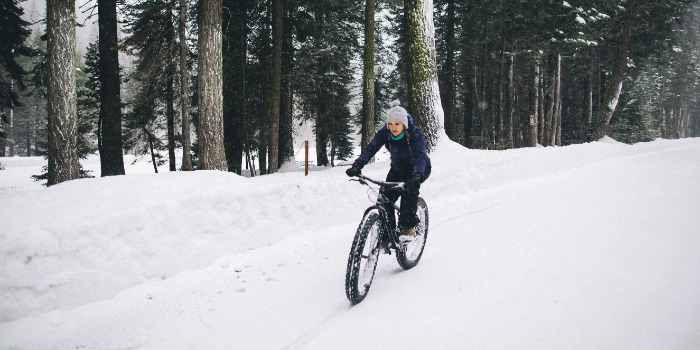 person cycling in the snow