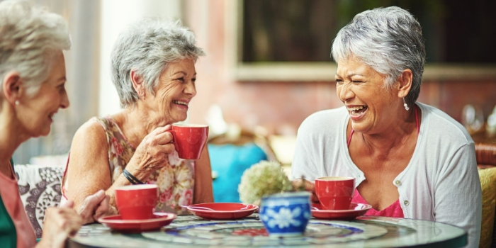 three people laughing over lunch