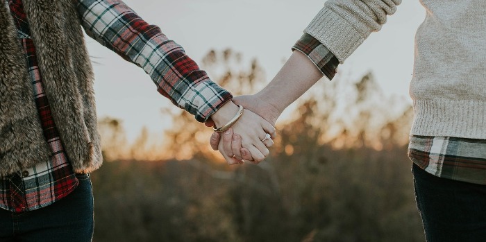 couple holding hands outdoors