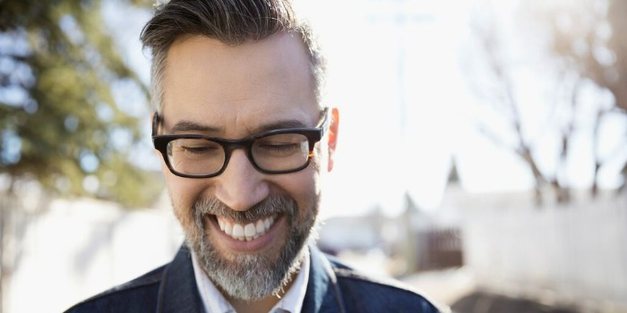 person smiling and walking
