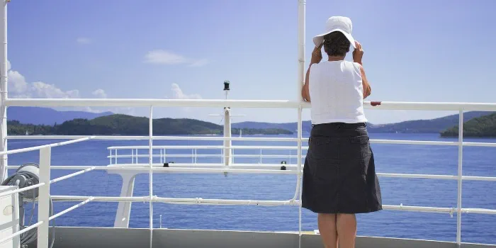 person on boat, looking out at the sea