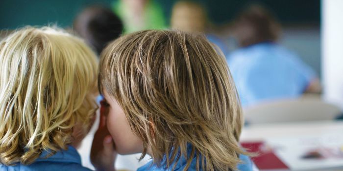 children whispering in class