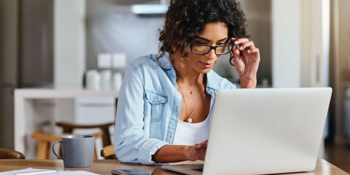 person sitting at a table with a laptop
