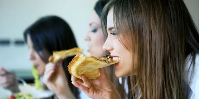 group of people eating pizza
