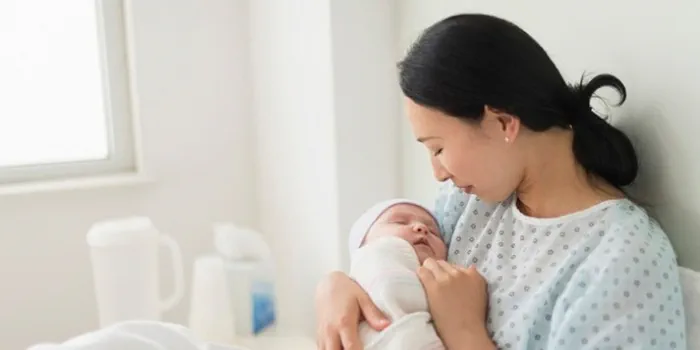 woman holding a baby in the hospital