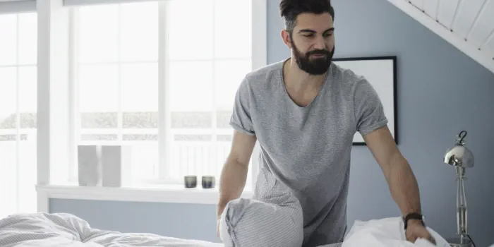 an adult changing bedsheets