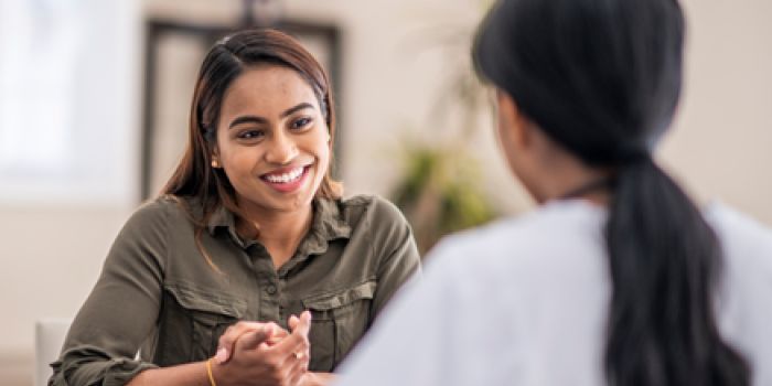 two people chatting and smiling