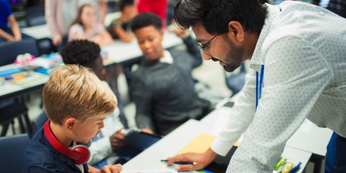 A teacher talking to a child