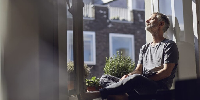 person sitting by the window on a sunny day