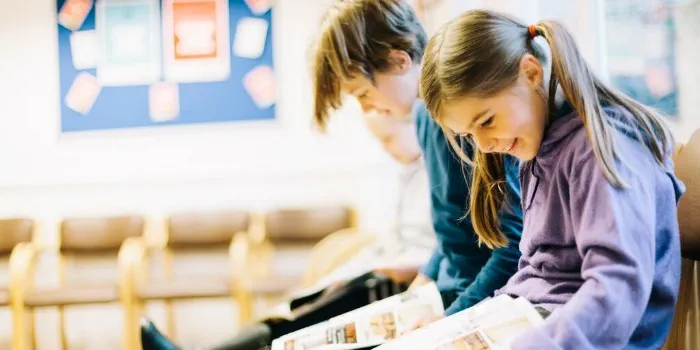 children reading books in a waiting room