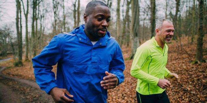 two people running in the woods
