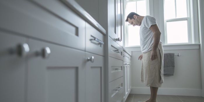 person checking weight on a scale at home