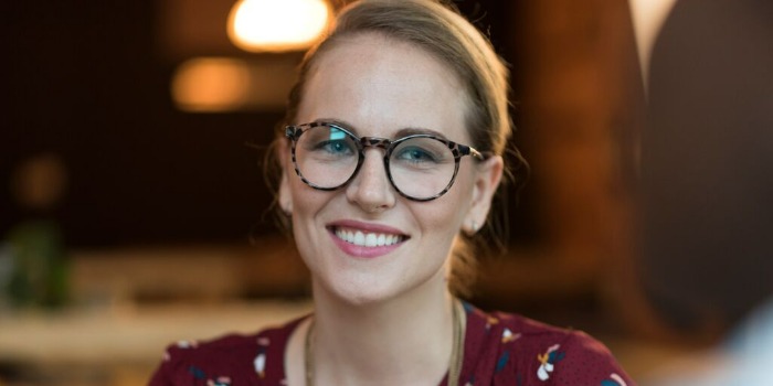 smiling person in a red shirt