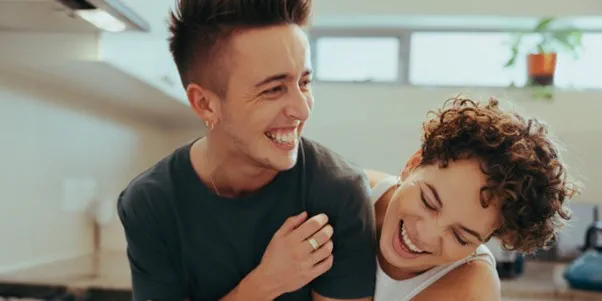 two people being playful in the kitchen