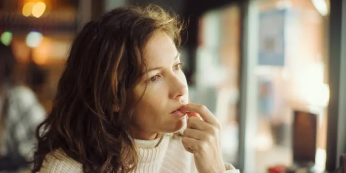 woman looking into a distance in thought