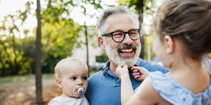 child using dummy with parents