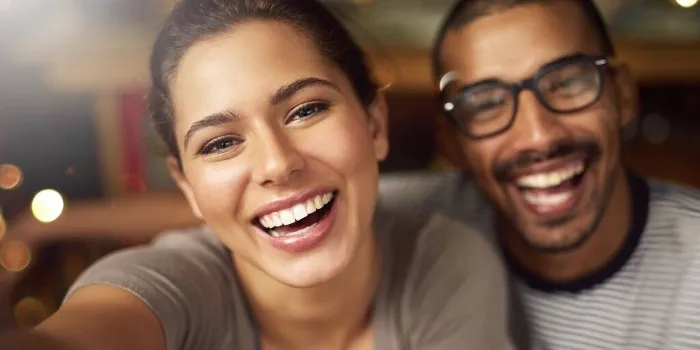 couple smiles together facing camera