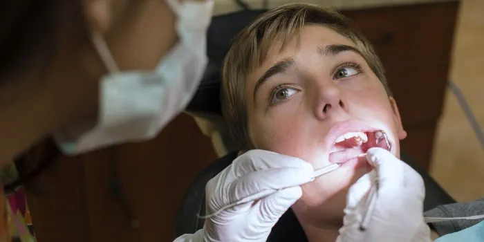 person having teeth checked at the dentist