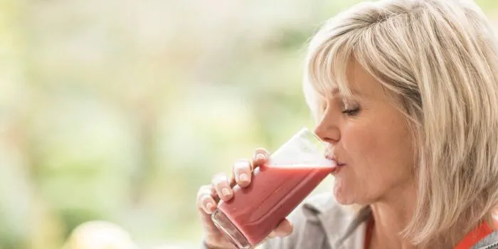 woman drinking a fruit smoothie