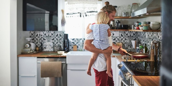 parent and child making breakfast in the kitchen