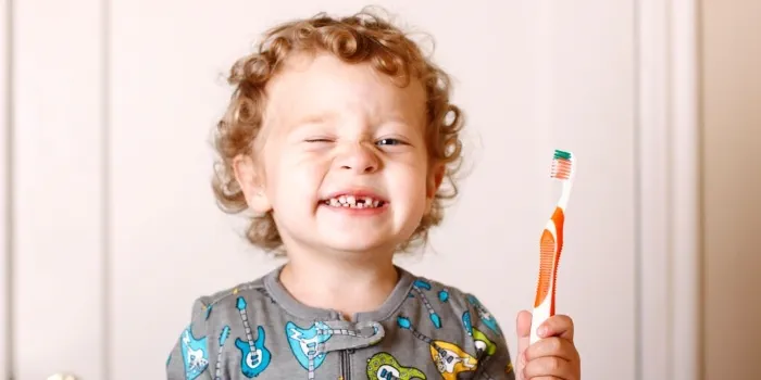child smiling after brushing teeth