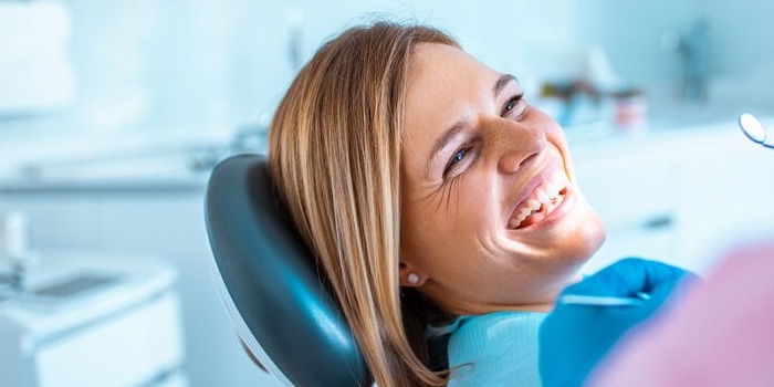 smiling patient in a dentist's chair