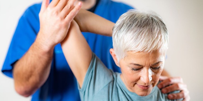 shoulder stretches guided by a physio