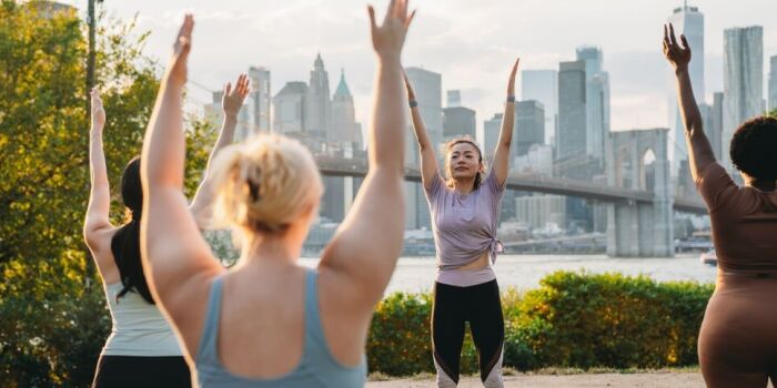 group doing yoga in the park