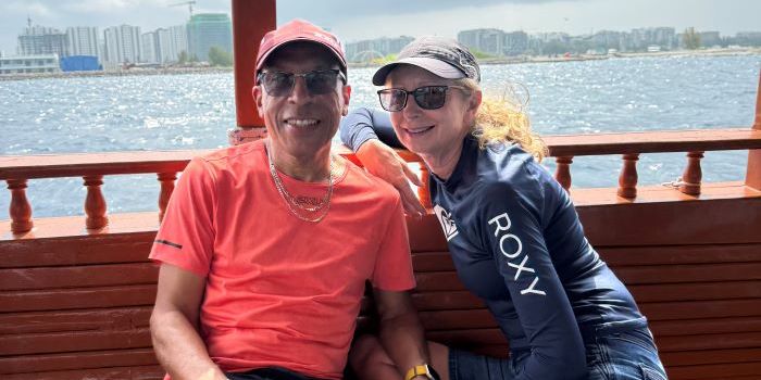 man on holiday with partner smiling