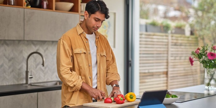 man cooking a recipe using ipad