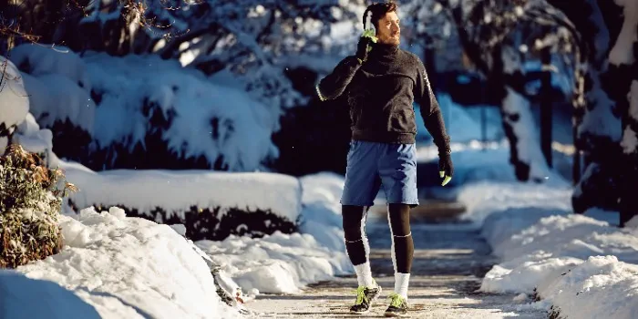 runner pausing in the snow