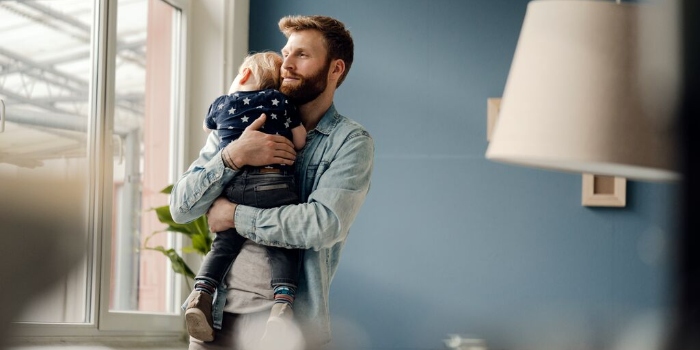 father holding baby to sleep