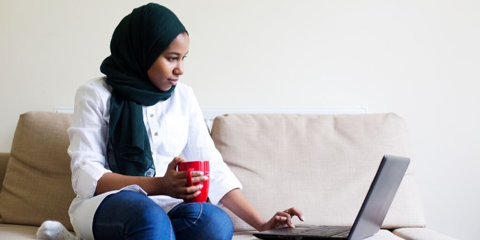women sat looking at laptop