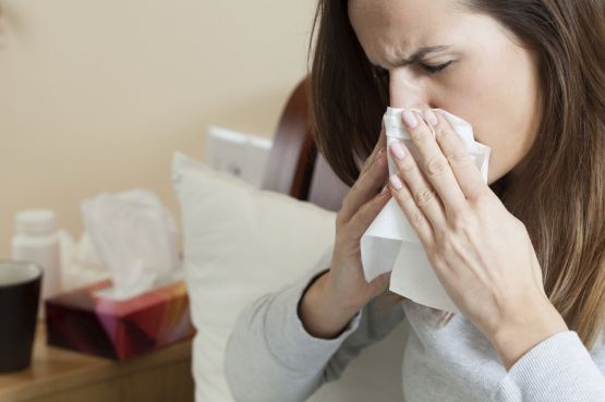 Woman blowing her nose