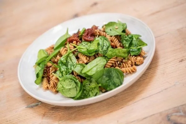 plate of spinach, broad bean, chicken wholemeal pasta