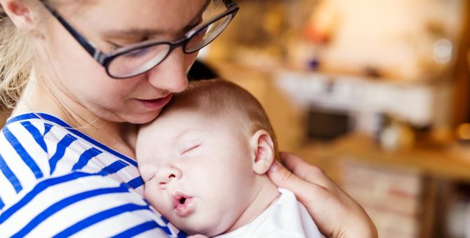 A woman is holding her baby