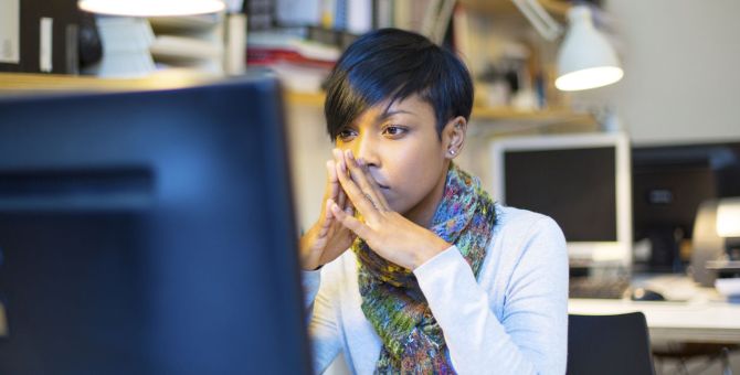 A woman working at her desk looking focused