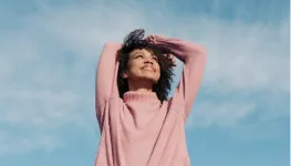 A woman with her hands on her head