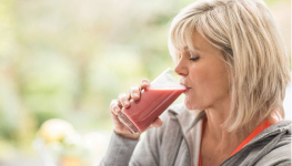 person drinking fruit smoothie