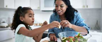 Mother and daughter preparing food