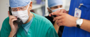 A surgeon speaking on the phone