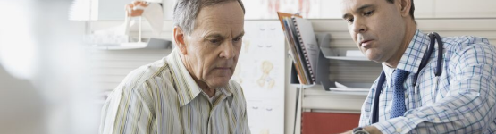 Doctor talking to elderly man
