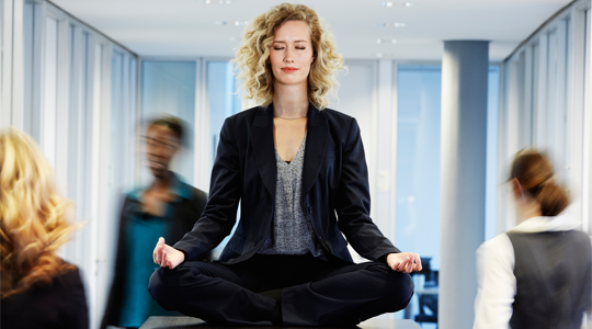 Woman meditating in office