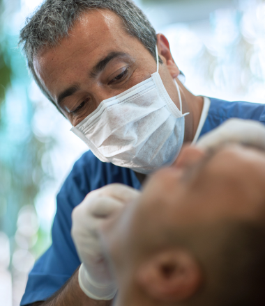 dentist-checking-teeth-of-patient