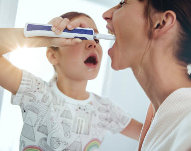 daughter-helping-mother-for-brushing-teeth