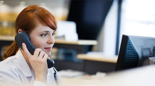 lady in an office answering the phone