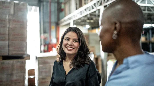 two colleagues in the warehouse talking